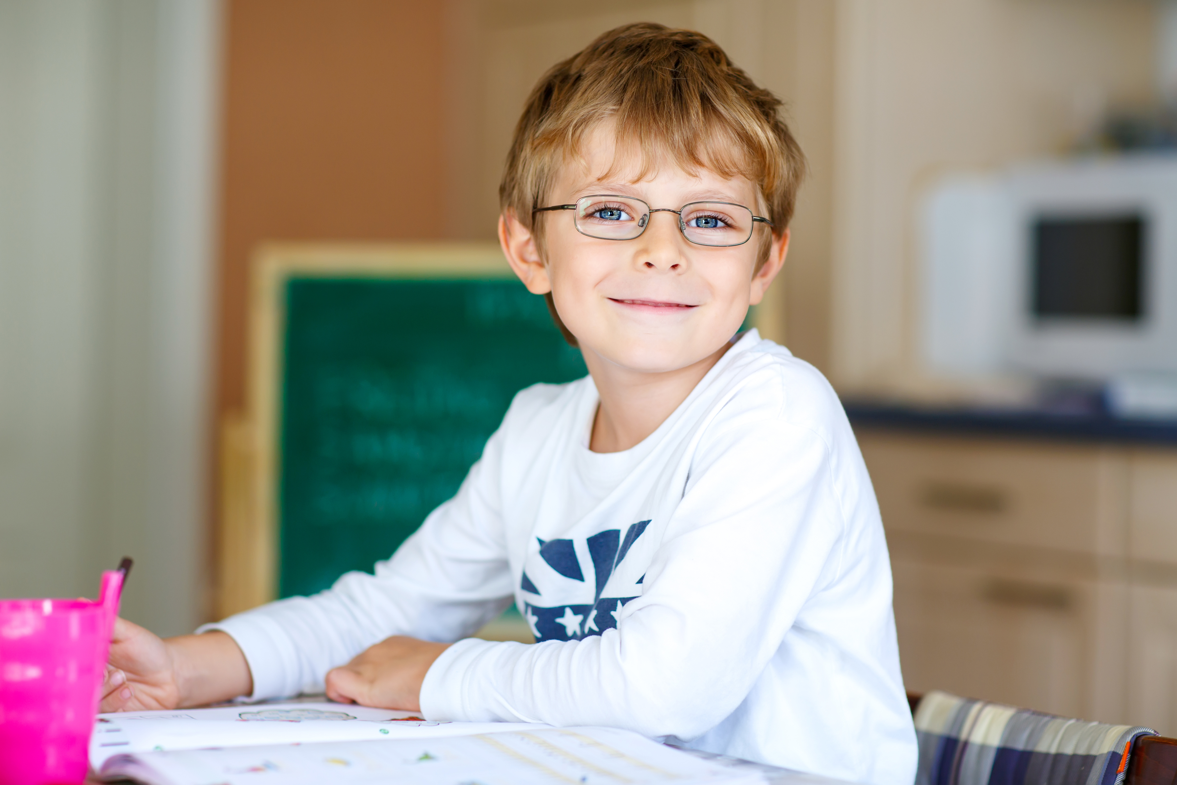 Happy young boy working on foreign language homework