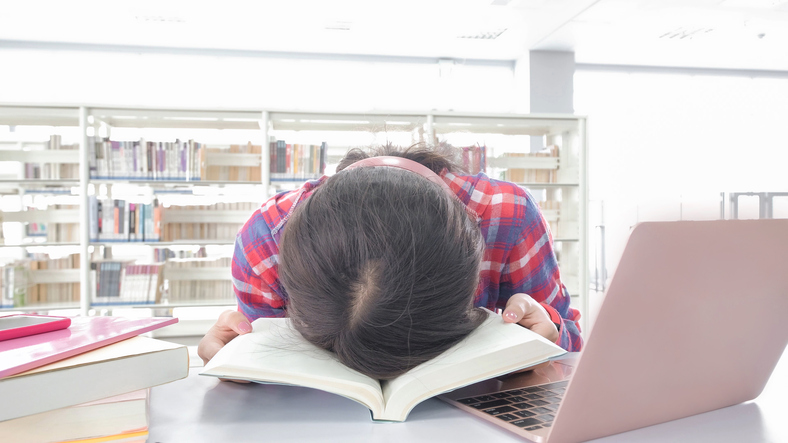 Asian student study and feel tired in the library