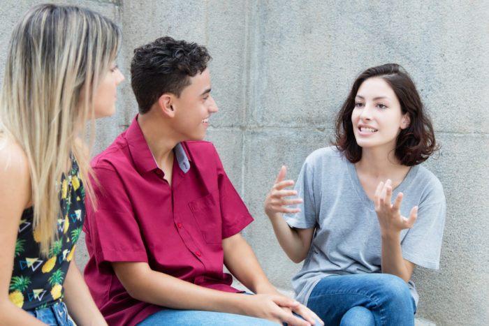 Image of 3 teens talking. 